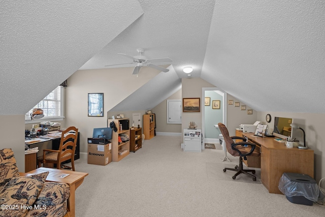 home office featuring a textured ceiling, a ceiling fan, lofted ceiling, and carpet floors