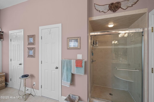 bathroom featuring tile patterned floors and a shower stall