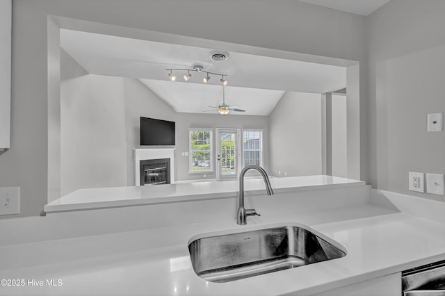 6211 Wrightsville Ave Unit 111, Wilmington, NC 28403 - kitchen featuring ceiling fan, vaulted ceiling, a glass covered fireplace, light countertops, and open floor plan