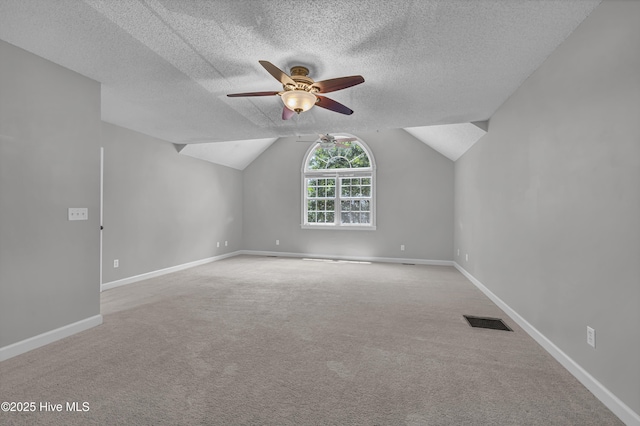 6211 Wrightsville Ave Unit 111, Wilmington, NC 28403 - additional living space featuring ceiling fan, a textured ceiling, carpet, and vaulted ceiling