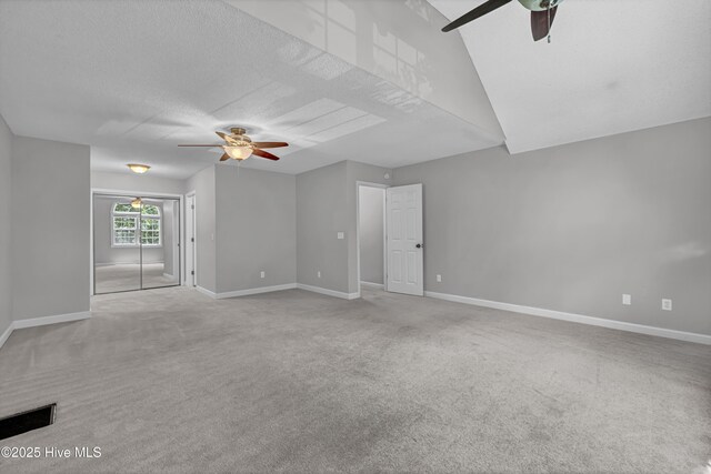 6211 Wrightsville Ave Unit 111, Wilmington, NC 28403 - unfurnished living room featuring ceiling fan, carpet floors, and a textured ceiling