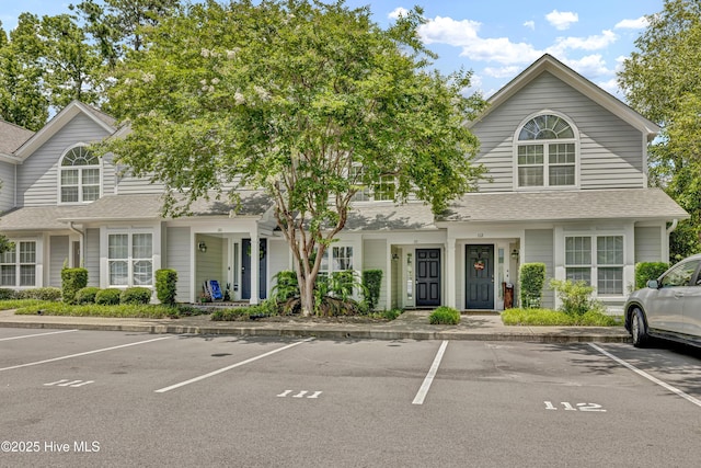 6211 Wrightsville Ave Unit 111, Wilmington, NC 28403 - view of property featuring uncovered parking and a shingled roof