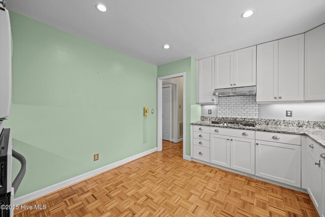 kitchen featuring white cabinets, stainless steel gas cooktop, under cabinet range hood, and recessed lighting