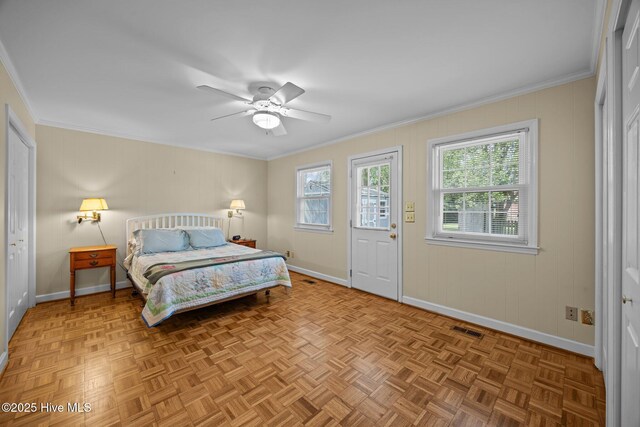 bedroom featuring baseboards, visible vents, ornamental molding, and ceiling fan
