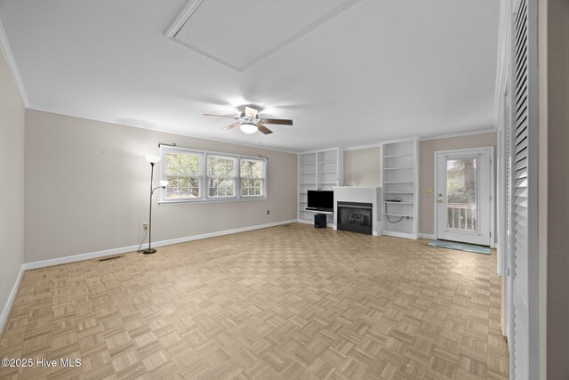 unfurnished living room with ceiling fan, visible vents, crown molding, a fireplace, and baseboards