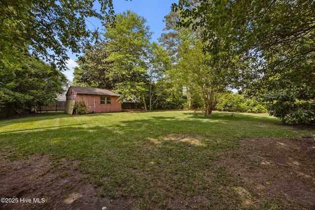 view of yard with an outdoor structure and a fenced backyard