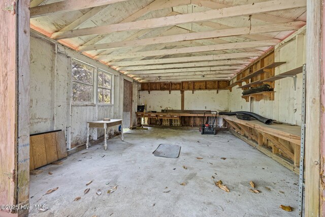 miscellaneous room featuring concrete flooring and a workshop area