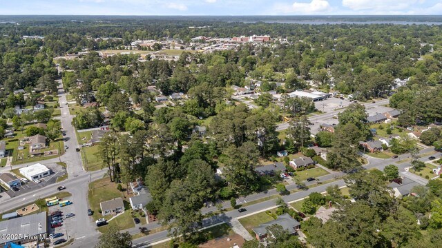 birds eye view of property with a forest view