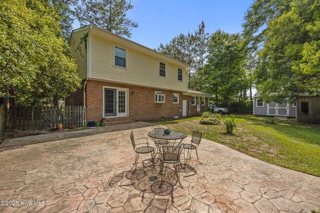 rear view of property featuring brick siding, a storage shed, entry steps, a patio area, and an outdoor structure