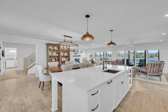 7522 Dunbar Rd, Wilmington, NC 28411 - kitchen featuring open floor plan, recessed lighting, light wood-style floors, plenty of natural light, and hanging light fixtures