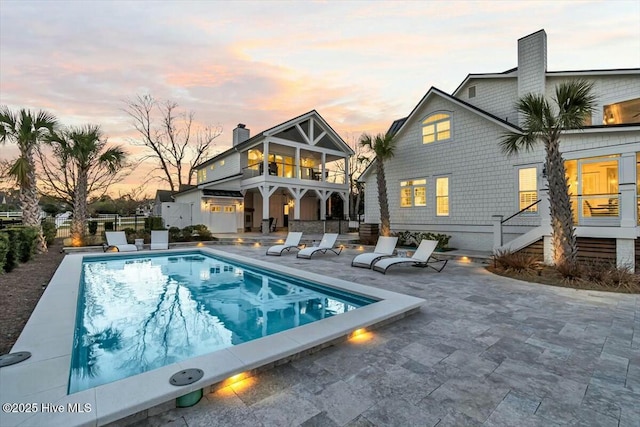 7522 Dunbar Rd, Wilmington, NC 28411 - rear view of house with a patio area, a chimney, and a balcony