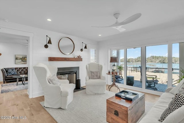7522 Dunbar Rd, Wilmington, NC 28411 - living area with ceiling fan, a glass covered fireplace, a water view, light wood-style flooring, and recessed lighting