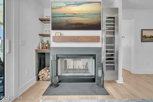 7522 Dunbar Rd, Wilmington, NC 28411 - detailed view of wood finished floors and a fireplace with flush hearth