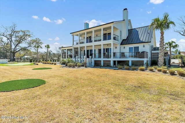 7522 Dunbar Rd, Wilmington, NC 28411 - rear view of property with a balcony, a chimney, a standing seam roof, and a metal roof