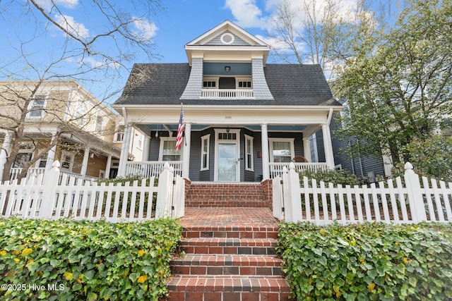 view of front facade with a porch and a fenced front yard