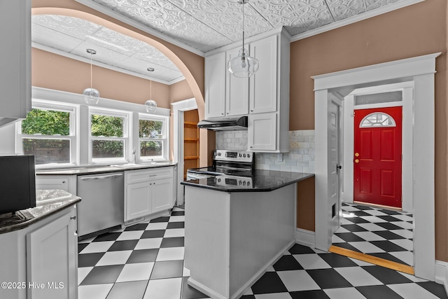 kitchen with white cabinets, appliances with stainless steel finishes, dark floors, a peninsula, and under cabinet range hood