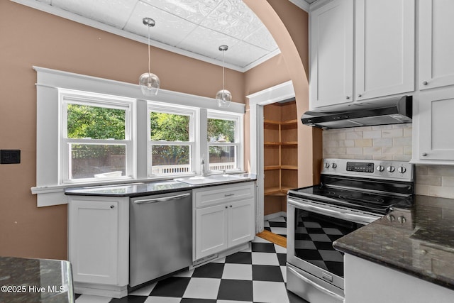 kitchen featuring decorative backsplash, appliances with stainless steel finishes, a sink, tile patterned floors, and under cabinet range hood