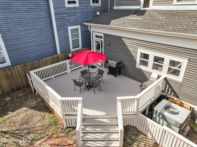 wooden deck featuring area for grilling, fence, and an outdoor living space with a fire pit