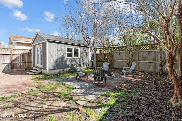 back of house with a fenced backyard, a patio area, an outbuilding, and entry steps
