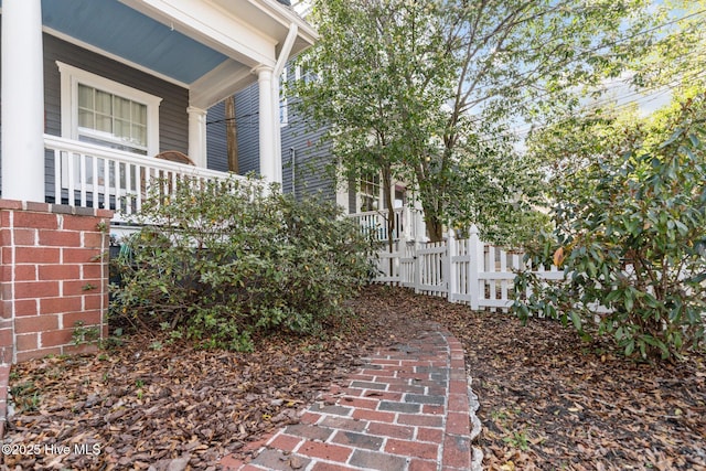 view of yard with fence and a porch