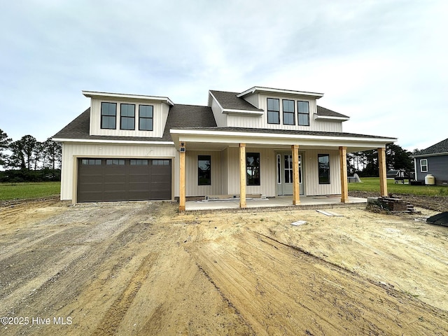 110 Blimp View Dr, Elizabeth City, NC 27909 - modern inspired farmhouse featuring covered porch, dirt driveway, and an attached garage