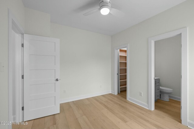 1615 Live Oak St Unit A & B, Beaufort, NC 28516 - unfurnished bedroom featuring a walk in closet, baseboards, a closet, and light wood finished floors