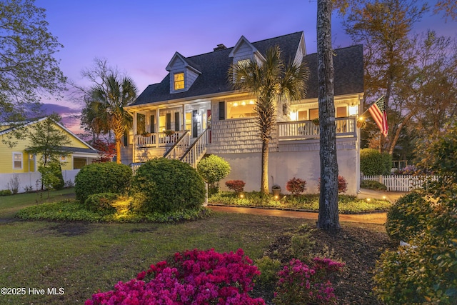 3001 E Yacht Dr, Oak Island, NC 28465 - cape cod-style house with a yard and fence