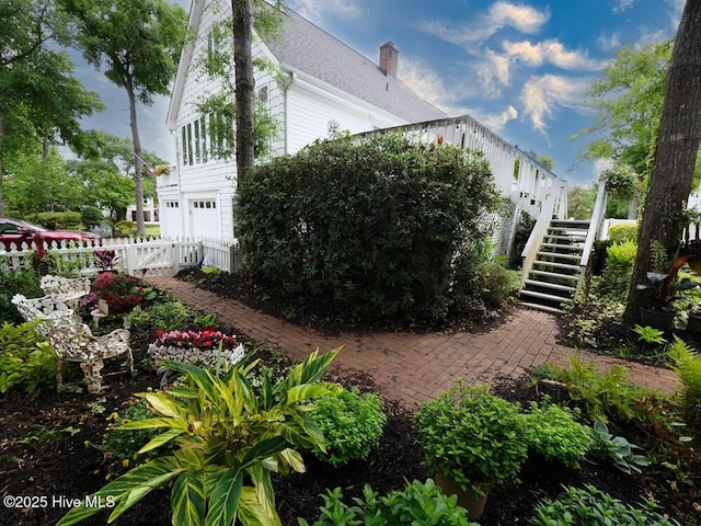 3001 E Yacht Dr, Oak Island, NC 28465 - view of home's exterior featuring stairway, a patio area, fence, a gate, and a garage
