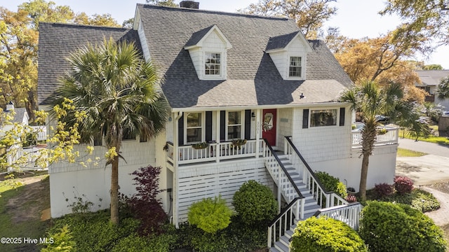 3001 E Yacht Dr, Oak Island, NC 28465 - view of front facade featuring stairway, roof with shingles, a chimney, and covered porch