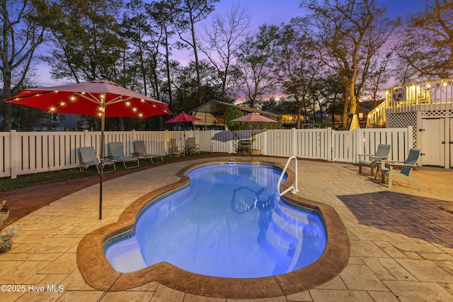 3001 E Yacht Dr, Oak Island, NC 28465 - pool at dusk with a patio, a fenced backyard, and a fenced in pool