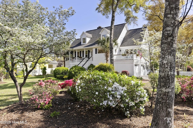 3001 E Yacht Dr, Oak Island, NC 28465 - view of front facade with stairway, roof with shingles, and a porch