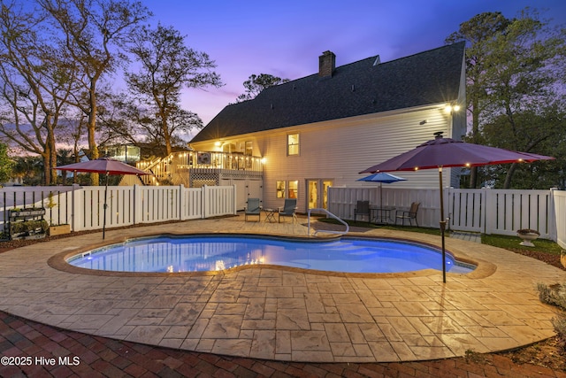 3001 E Yacht Dr, Oak Island, NC 28465 - pool at dusk featuring a fenced backyard, a fenced in pool, and a patio