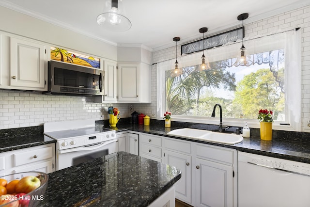 3001 E Yacht Dr, Oak Island, NC 28465 - kitchen with crown molding, white appliances, white cabinets, a sink, and backsplash