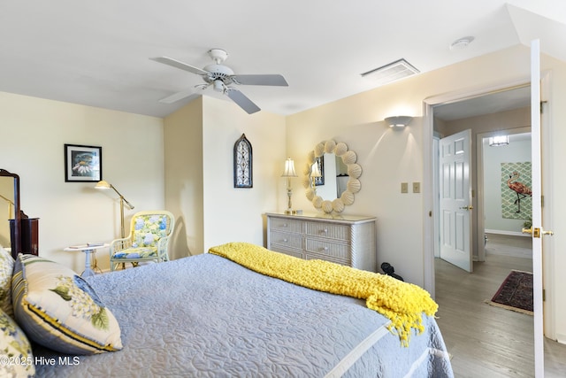 3001 E Yacht Dr, Oak Island, NC 28465 - bedroom featuring visible vents, ceiling fan, baseboards, and wood finished floors