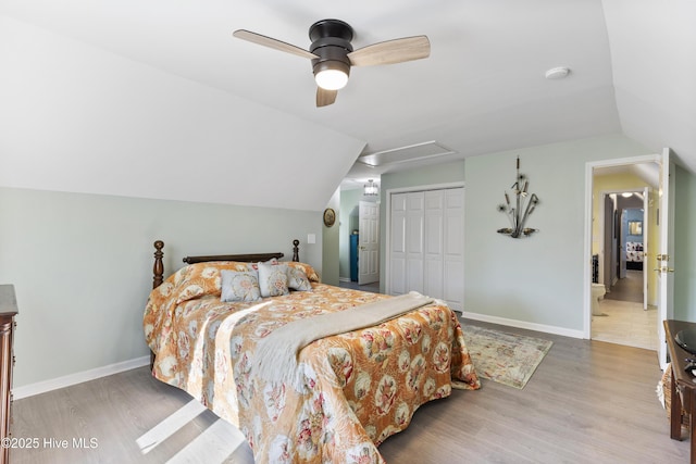 3001 E Yacht Dr, Oak Island, NC 28465 - bedroom featuring lofted ceiling, baseboards, a closet, ceiling fan, and wood finished floors