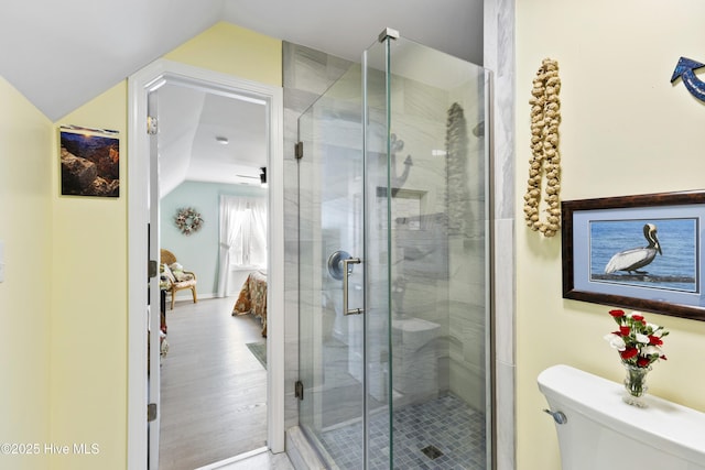 3001 E Yacht Dr, Oak Island, NC 28465 - ensuite bathroom with ensuite bath, vaulted ceiling, toilet, wood finished floors, and a stall shower