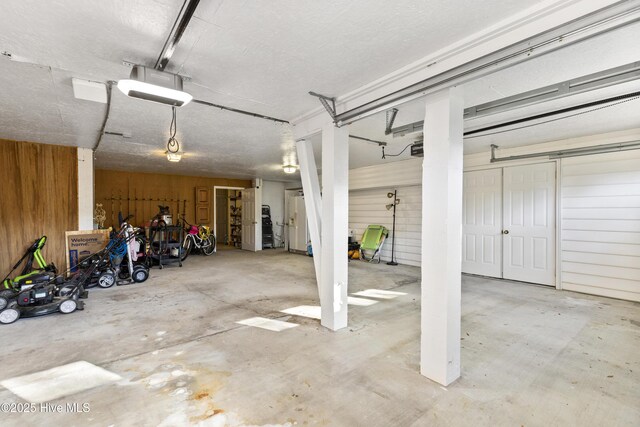3001 E Yacht Dr, Oak Island, NC 28465 - garage with wooden walls and a garage door opener