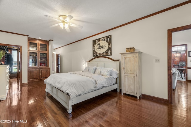 bedroom with baseboards, a ceiling fan, ornamental molding, and dark wood-style flooring