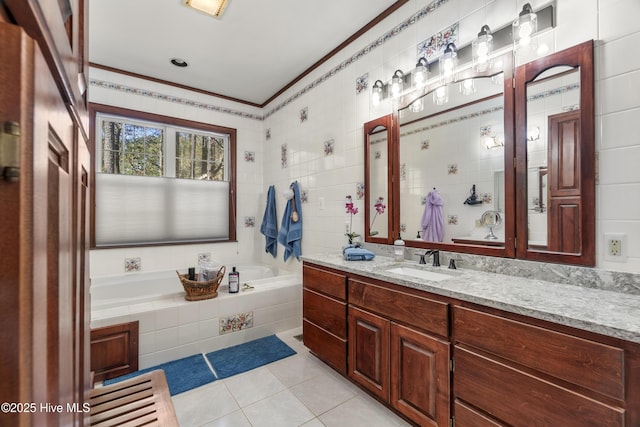 full bathroom featuring tile patterned flooring, vanity, tile walls, ornamental molding, and a garden tub