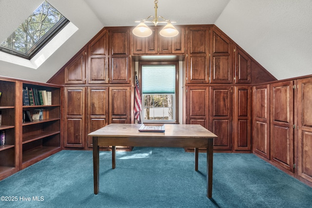 unfurnished office featuring vaulted ceiling with skylight, wood walls, and carpet floors
