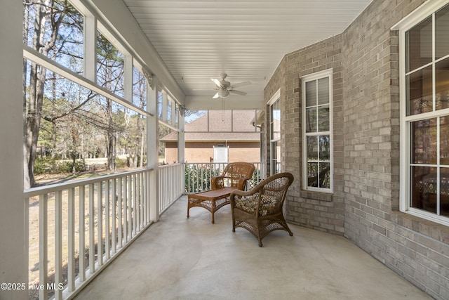 sunroom featuring ceiling fan