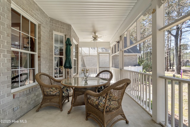 sunroom / solarium with a ceiling fan