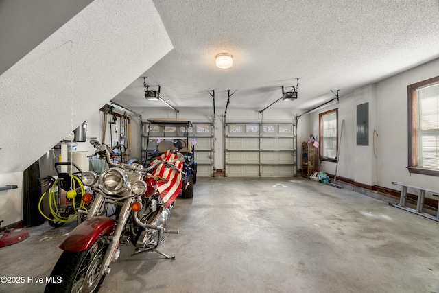 garage with baseboards, a garage door opener, and electric panel