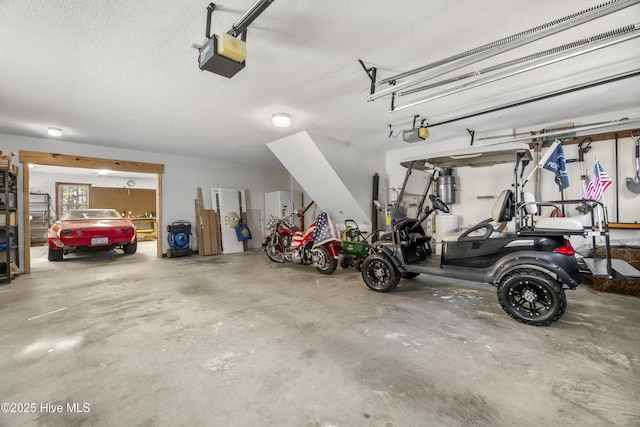 garage with water heater and a garage door opener