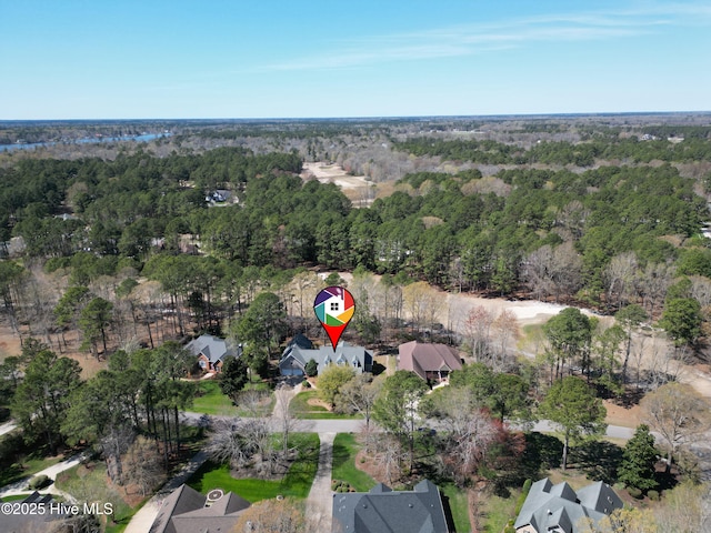 birds eye view of property with a view of trees