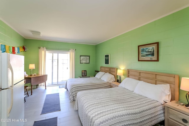 bedroom with crown molding and freestanding refrigerator