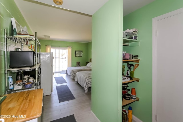 bedroom featuring freestanding refrigerator