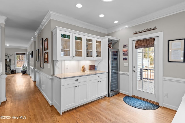 interior space featuring light stone countertops, white cabinetry, and light wood finished floors