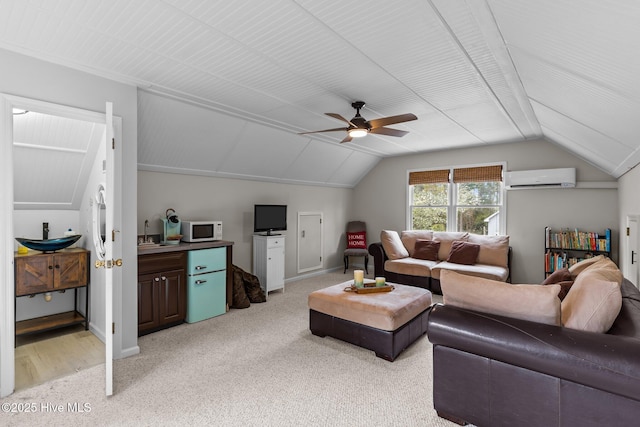 living area with ceiling fan, a wall mounted AC, light colored carpet, and vaulted ceiling