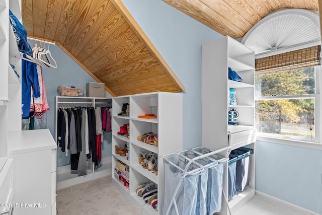 walk in closet featuring carpet flooring and vaulted ceiling